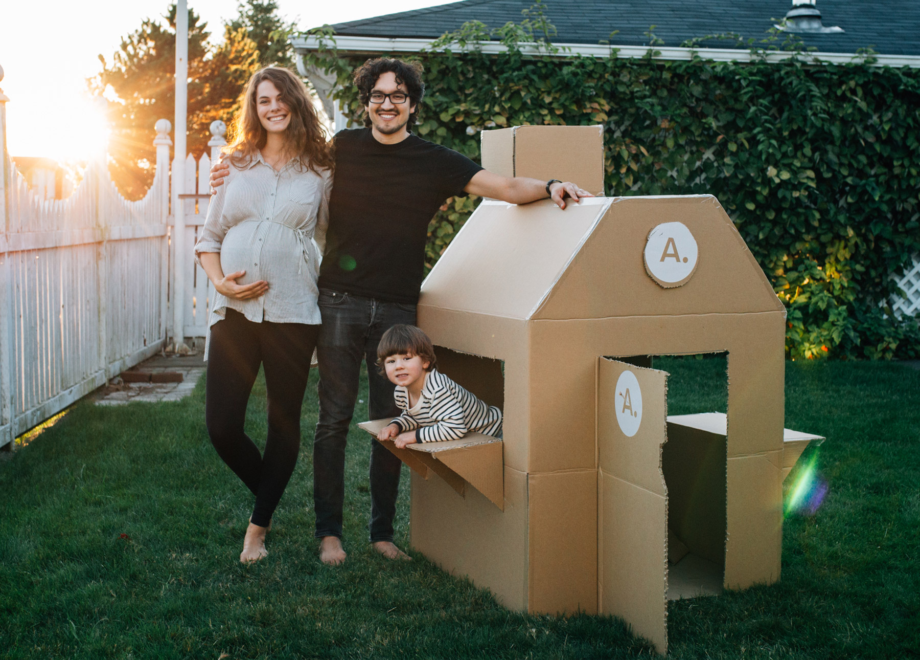 Jorge, Emmy Lou, and Matthias all pose excitedly with the fully completed box fort.