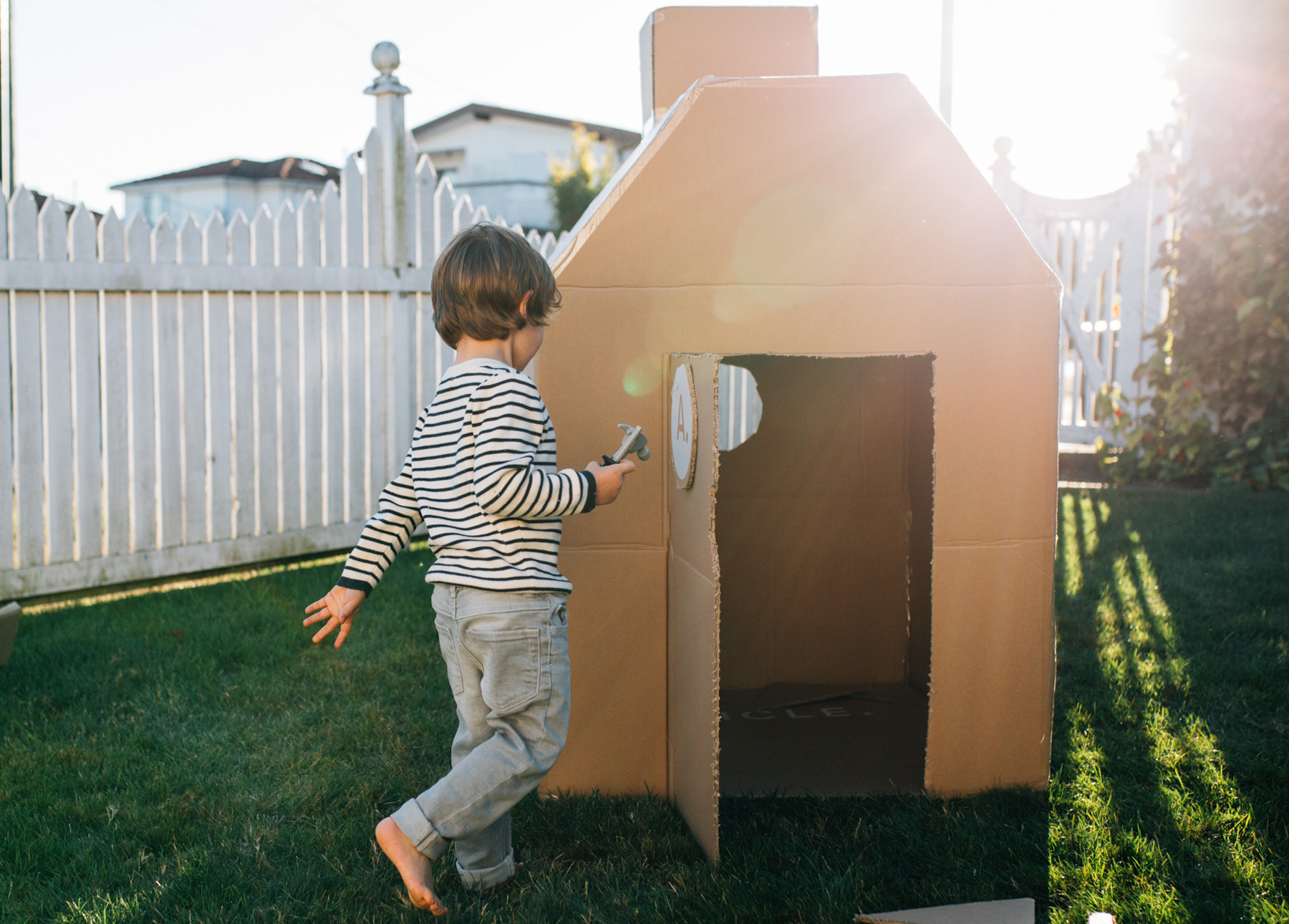 A child playing with a completed box fort