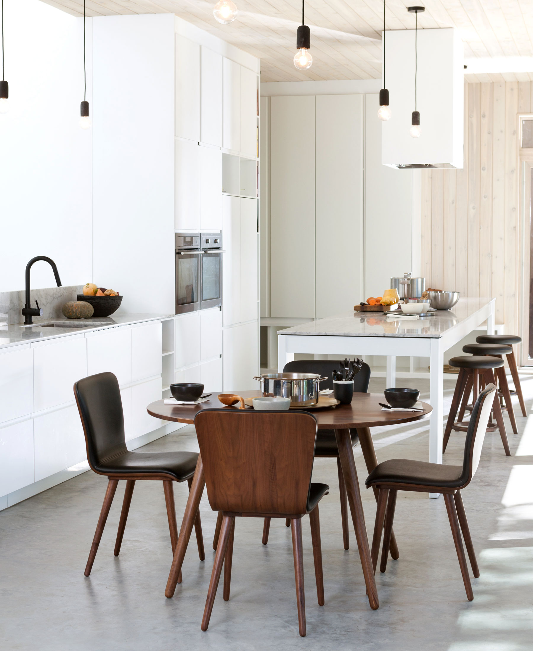 A modern Scandinavian-inspired open-concept kitchen and dining area.
