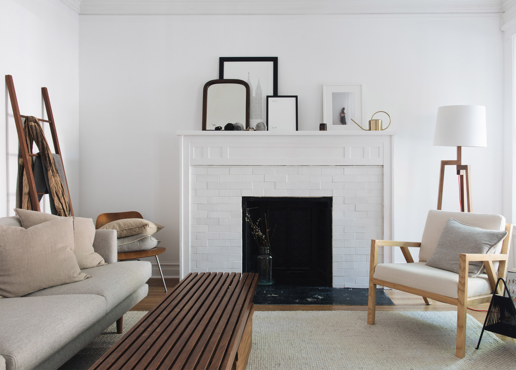 A white fireplace in a minimalist home.
